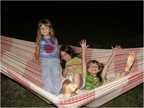 Madeline, Tessa and Adrianna playing in hammock in Venezuela