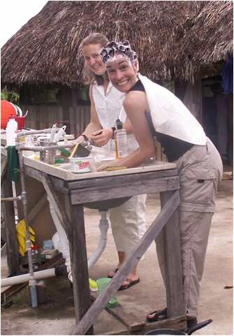 Corrie Sample with Susan Duehrssen washing her hair in the outdoor sink in Venezuela