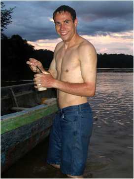 Daniel Adams taking a bath in the river near Aripichi, Venezuela