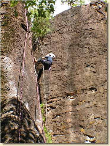 Benjamin Hunt halfway down the rappelling cliff