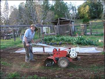 Celian Adams tilling garden at ranch in Mosquito