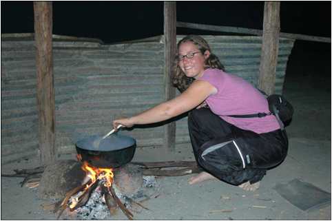 Corrie Sample prepares food in primitive conditions in Venezuela