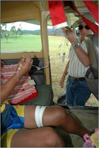 Mission pilot Bob Norton with snakebite victim in plane