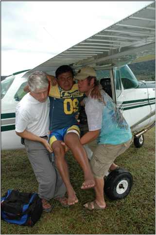 Dr. Mike and student unload snakebite victim from AMA plane in Venezuela