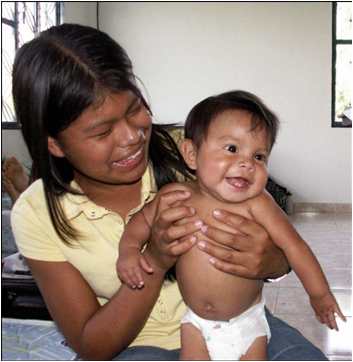 Venezuelan girl holds Ellers' newly-adopted baby