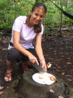 Emily Caza slicing potatoes with a machete