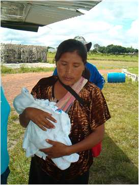 Lady with baby preparing to board mission plane