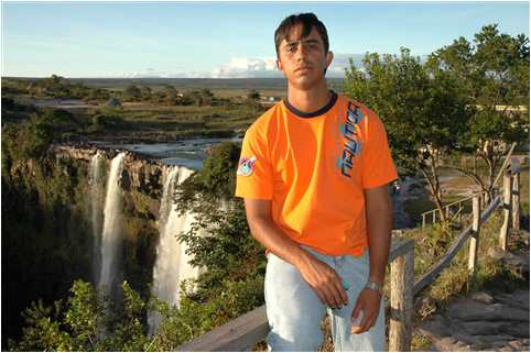 Venezuelan Student Missionary Henry Fernndez by waterfall