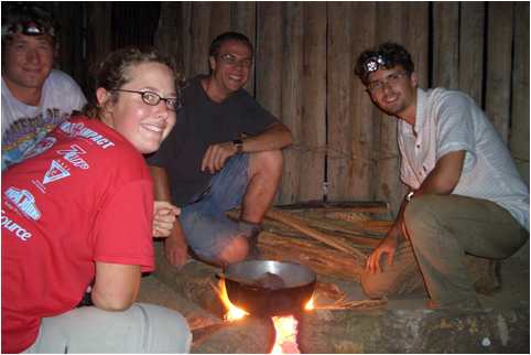 Michael Hoppe, Corrie Sample, Daniel Adams and Gerhard Weiner around cooking fire in Venezuela