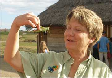 Kathy Bollinger eyes a giant grashhopper in Venezuela