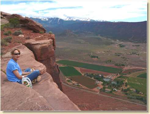 Diana Adams eating lunch on Parriott Mesa cliff edge