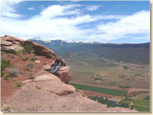 Daniel Adams perched on edge of Parriott Mesa cliff