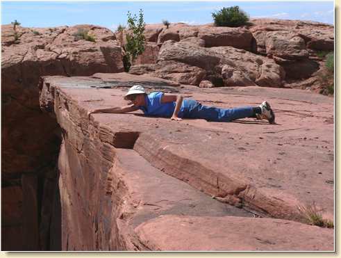 Diana Adams laying on Parriott Mesa clifftop