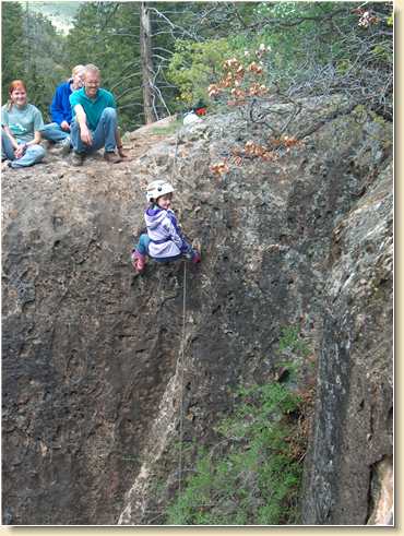 KK Medina rappels down cliff face