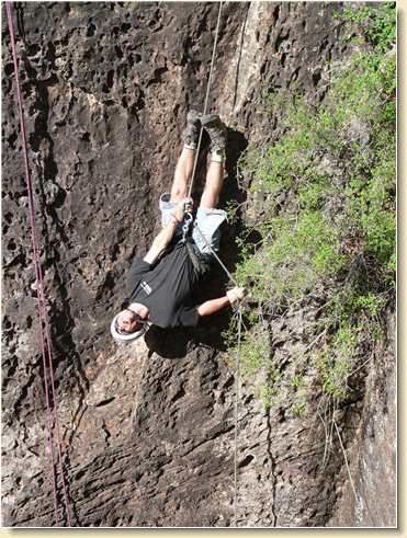 Daniel Adams rappelling upside down