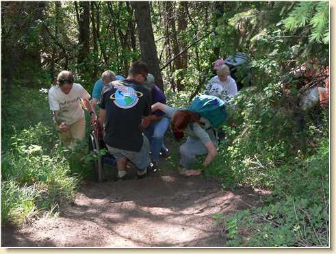 Tugging Fred in his wheelchair up the steep, slippery trail