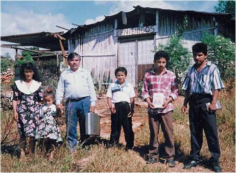 Adventist believers in front of primitive church in south Mexico