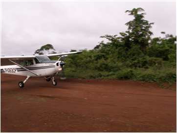 Mission plane landing on tiny airstrip